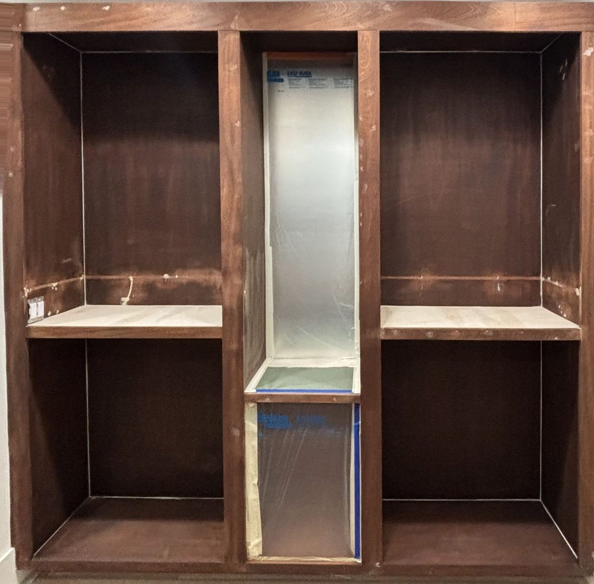 Dark stained closet built-ins before painting