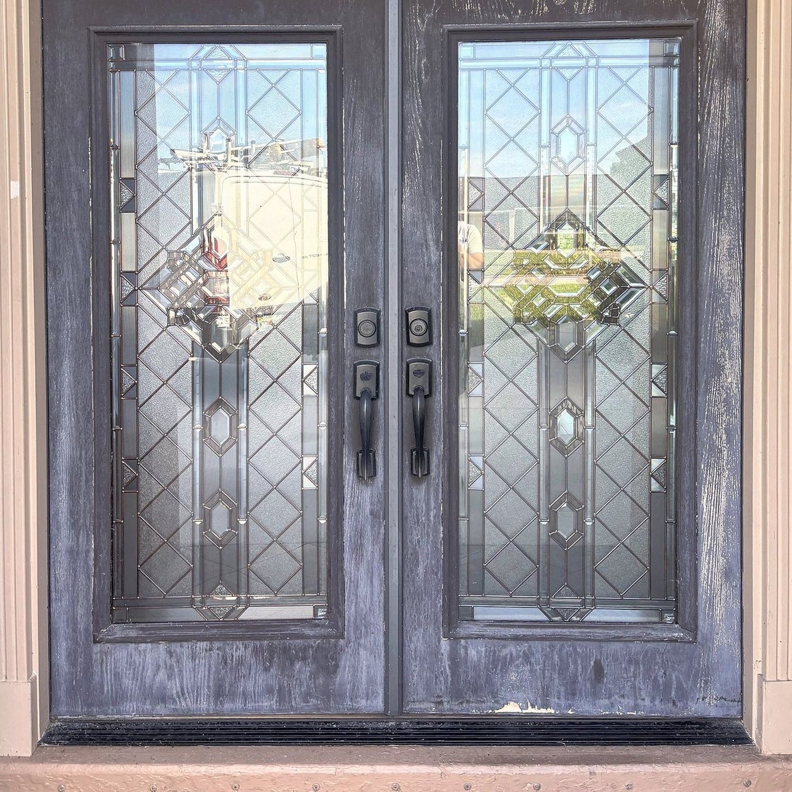Weathered front entry doors before refinishing
