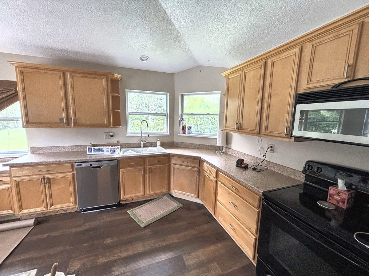 Kitchen with orange oak cabinets before painting