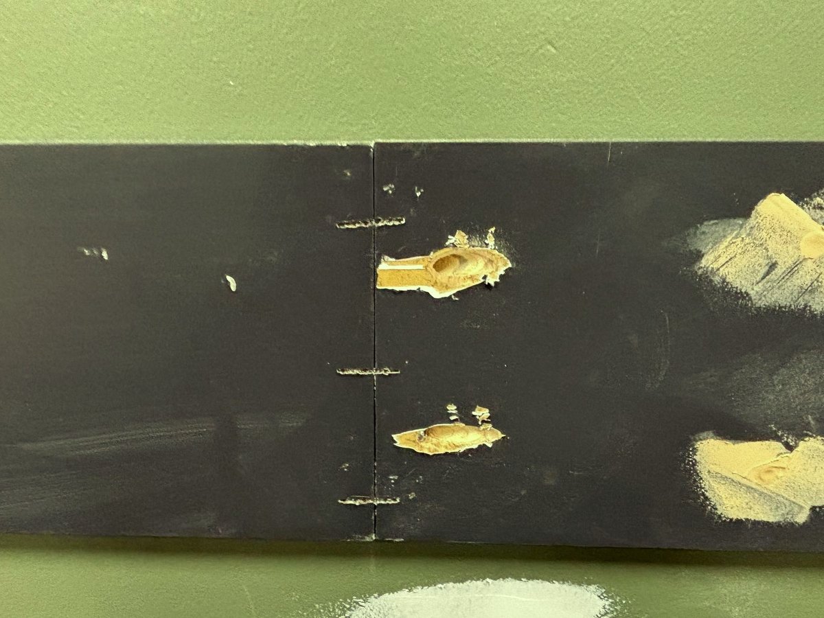 Damaged drywall and accent stripe before repair