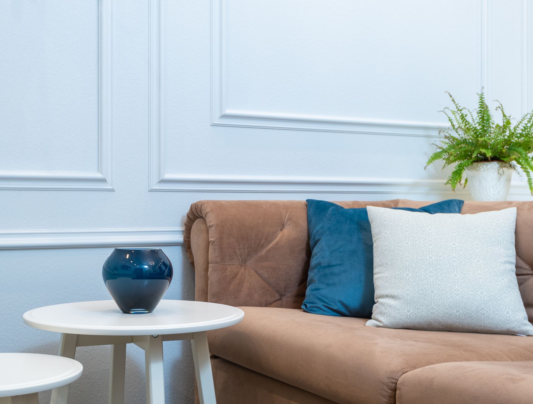 Living room with blue walls and white trim