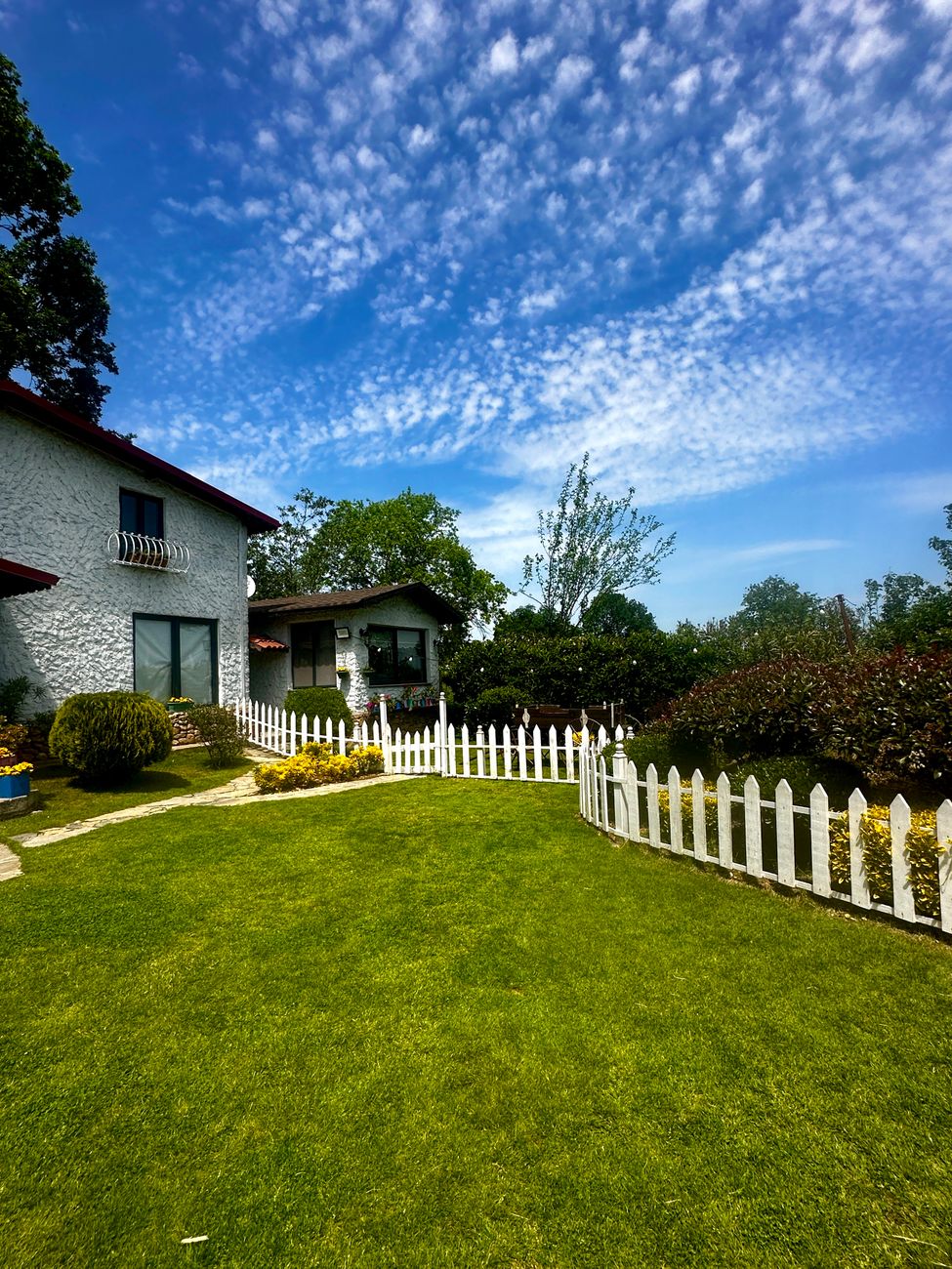 Home with a white picket fence and green lawn